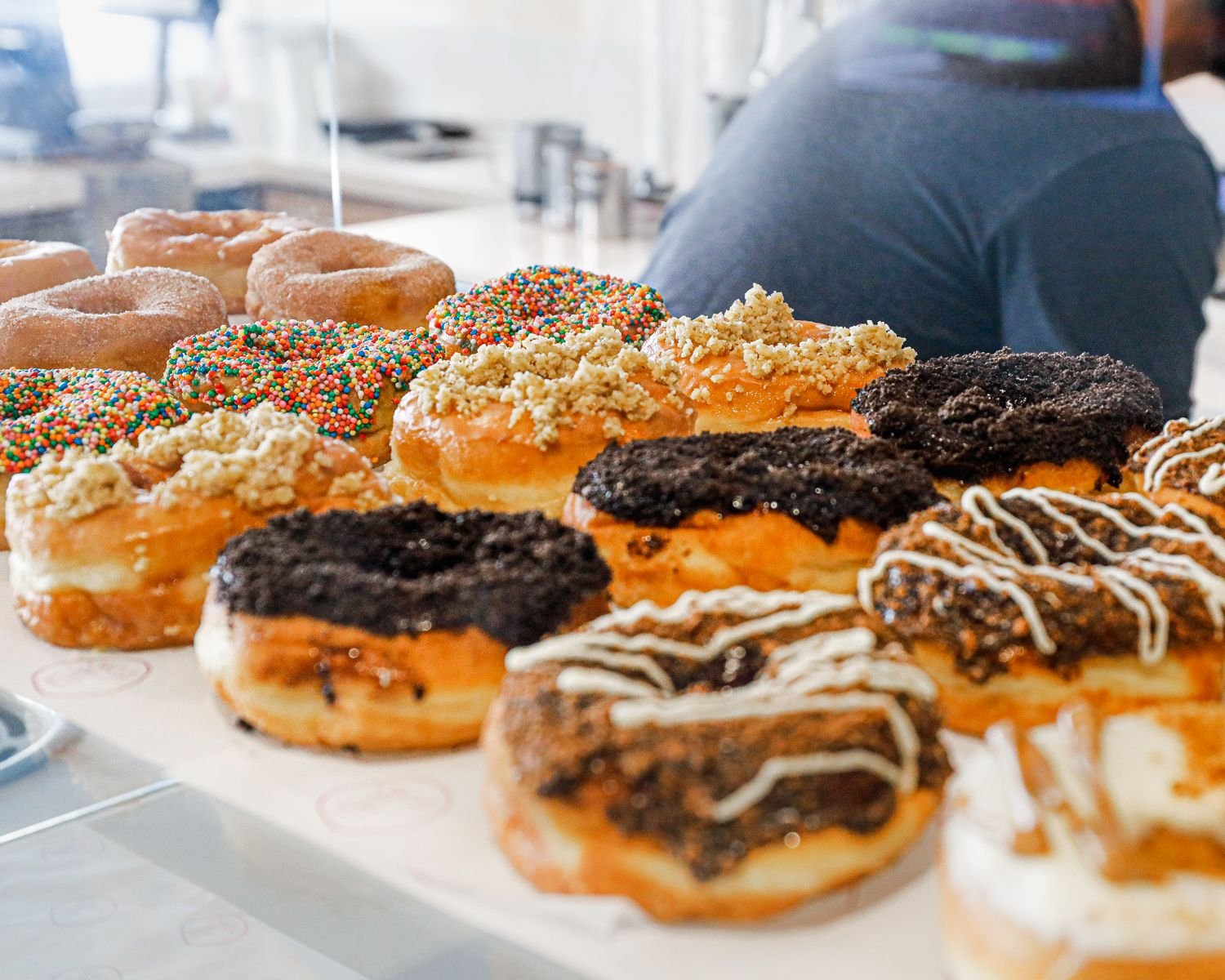 A close-up of Circle of Life doughnuts — sprinkles, crumble, Oreo and drizzle